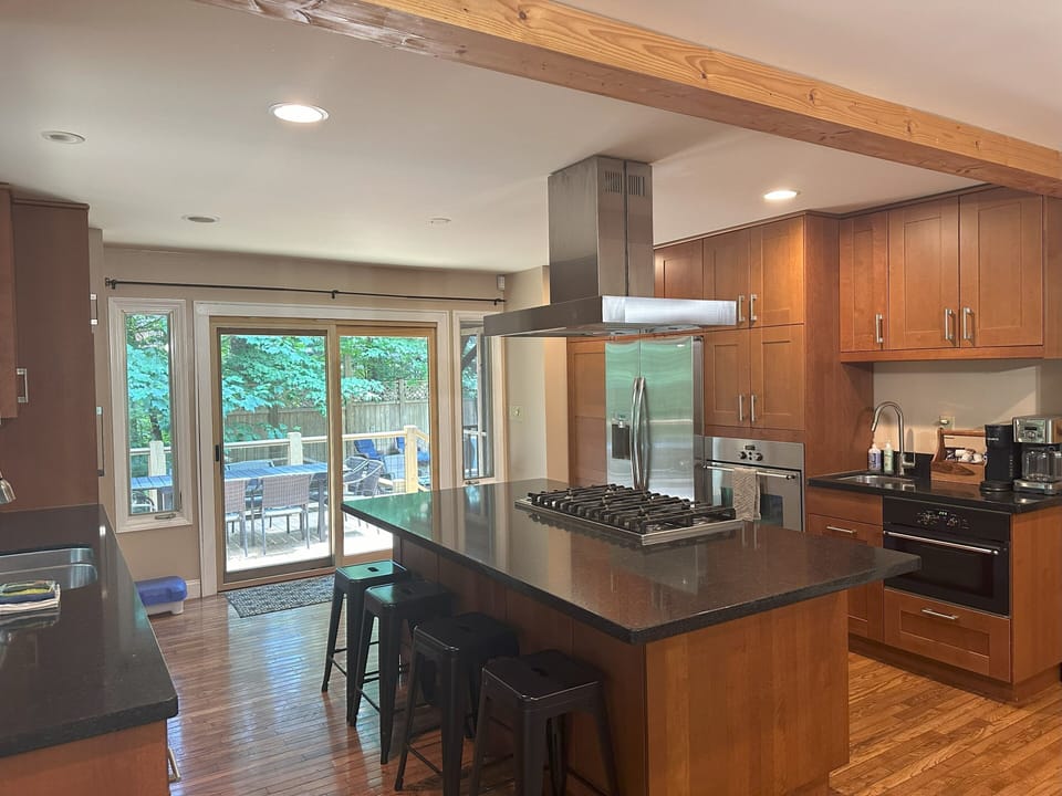 Gather around the Massive Kitchen Island for lunch or to assist the chef
