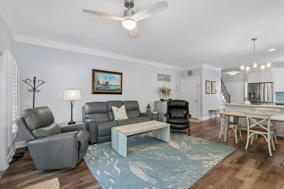 Unwind in your spacious living area, where soft coastal tones and plush seating invite relaxation after a day of adventures.
