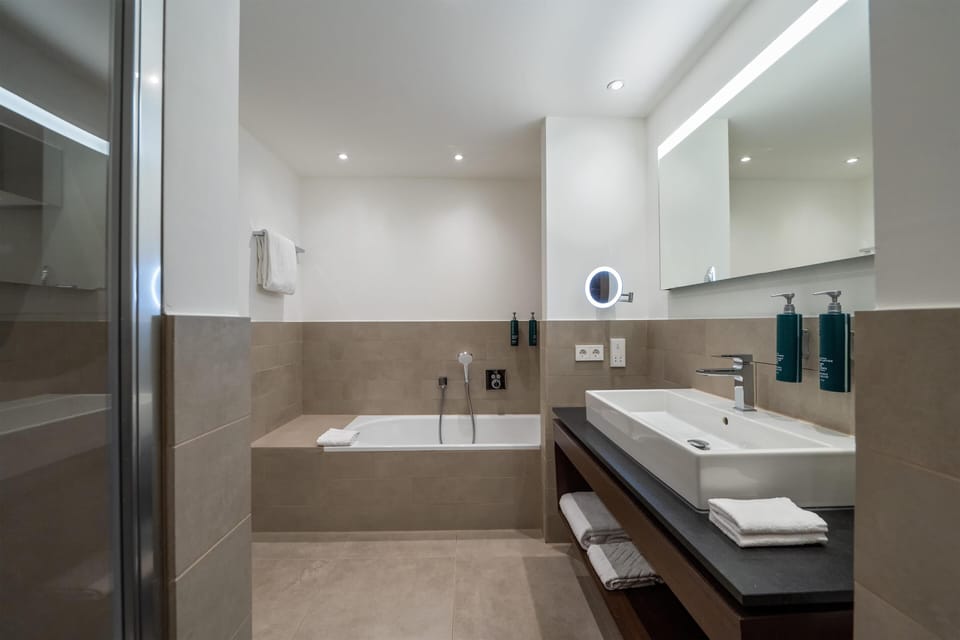 King Junior Suite Rhine Wing River View | Bathroom | Combined shower/tub, designer toiletries, hair dryer, slippers