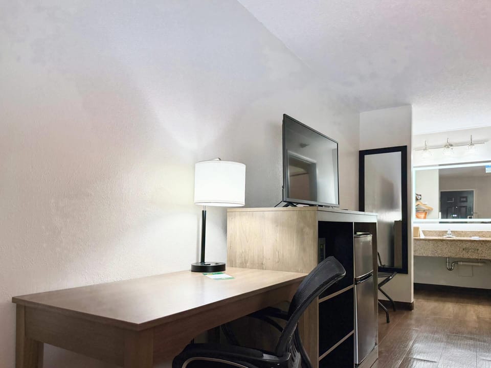 Premium bedding, desk, laptop workspace, blackout drapes