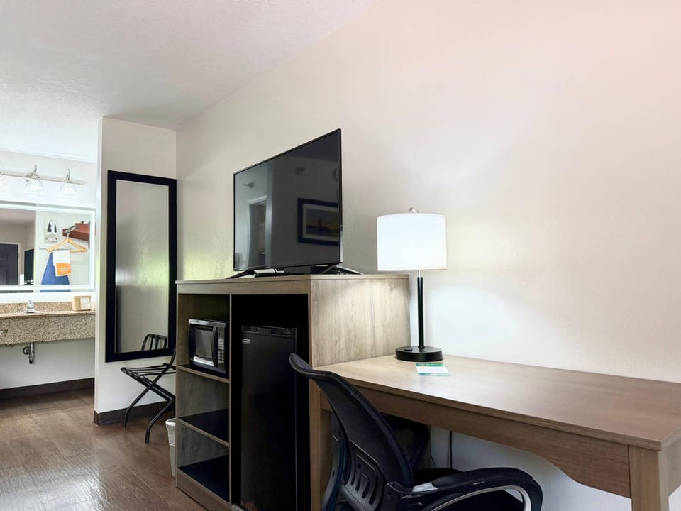 Premium bedding, desk, laptop workspace, blackout drapes