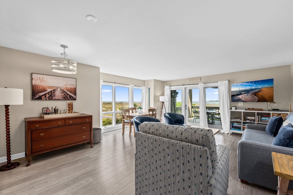 A beautiful wall of windows greets you with the beach beyond in the end unit.