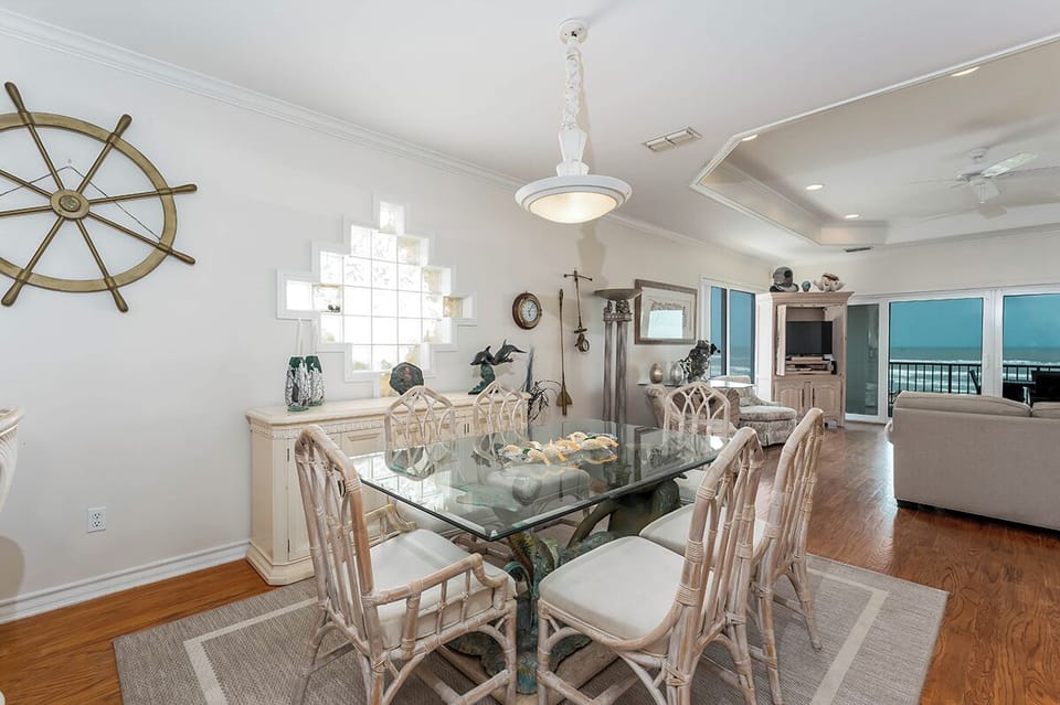 Gather around the glassâ€‘top dining table, perfect for family meals, while soaking in that beautiful beachfront view you came for.