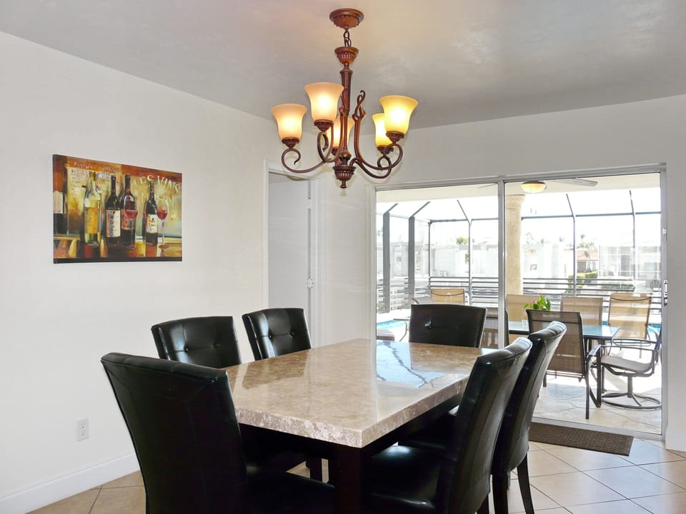 Dining area looking out at pool and canal.