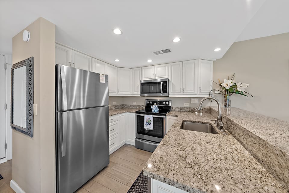 The kitchen has custom cabinets, granite counters and stainless steel appliances