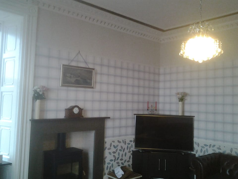 Living room with smart TV and wood burning stove