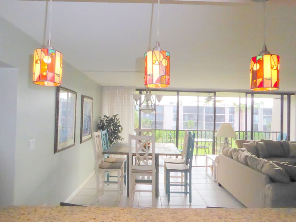 View of dining area from kitchen/bar with stools.