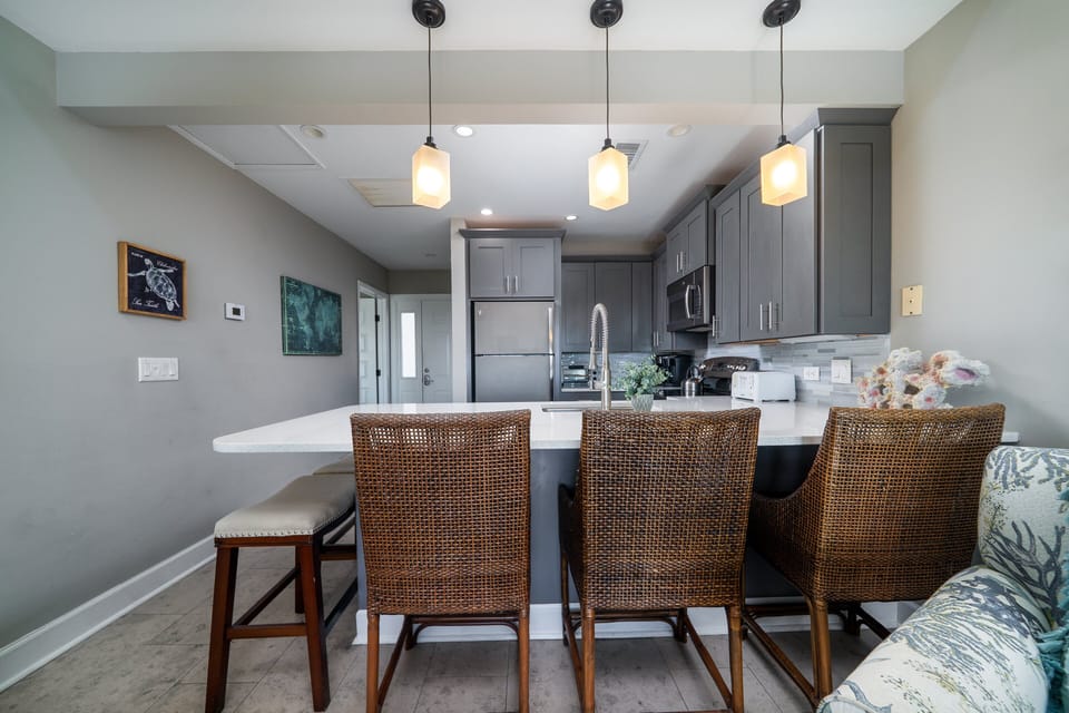 Gourmet kitchen opens up to the living room with amazing views of the ocean.