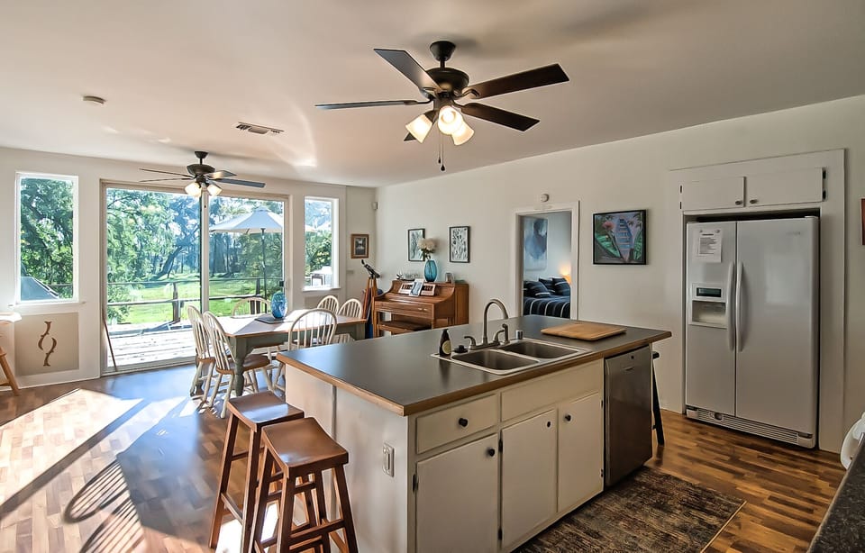 Huge kitchen with island seating, plus dining, tons of counter space, and a view