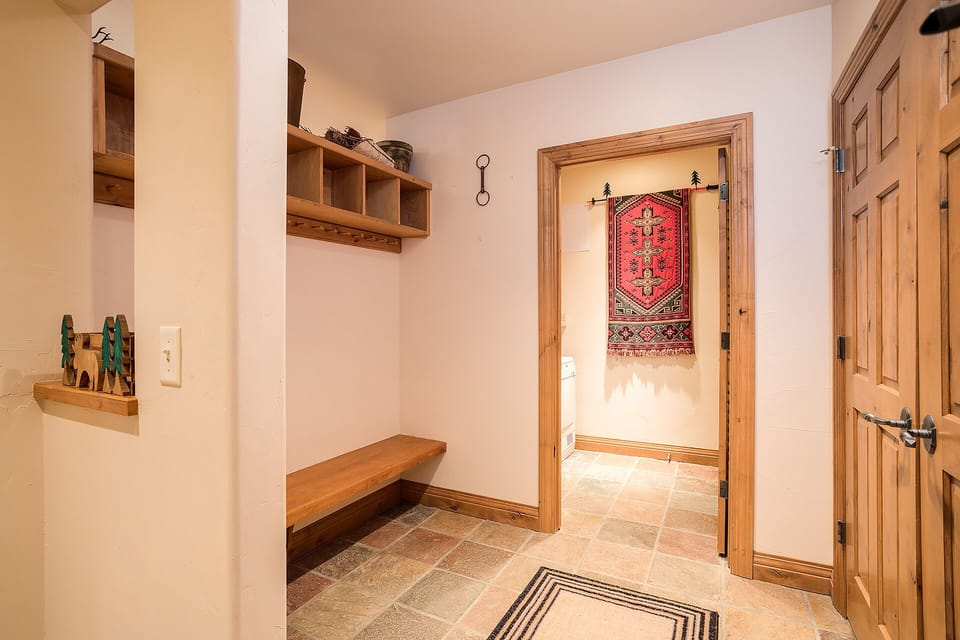 Your private mudroom features a cozy bench and storage cubbies—perfect for organizing gear after mountain adventures.