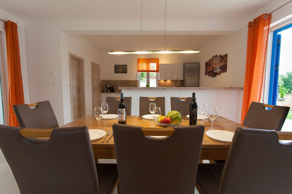 Dining area with kitchen in background