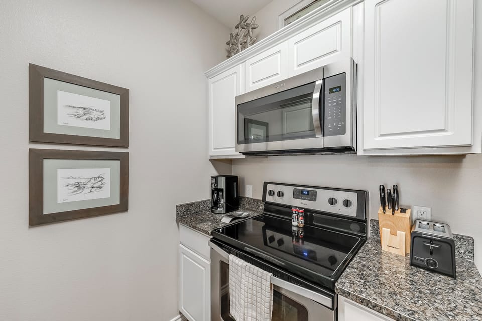 Your well-appointed kitchen features granite countertops, stainless steel appliances, and all the essentials for cooking memorable meals during your stay.