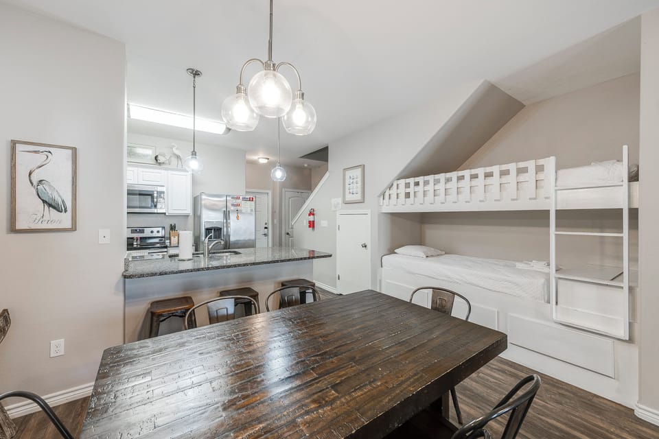 Gather around this rustic dining table for memorable meals, then relax in your cozy bunk beds nearby.