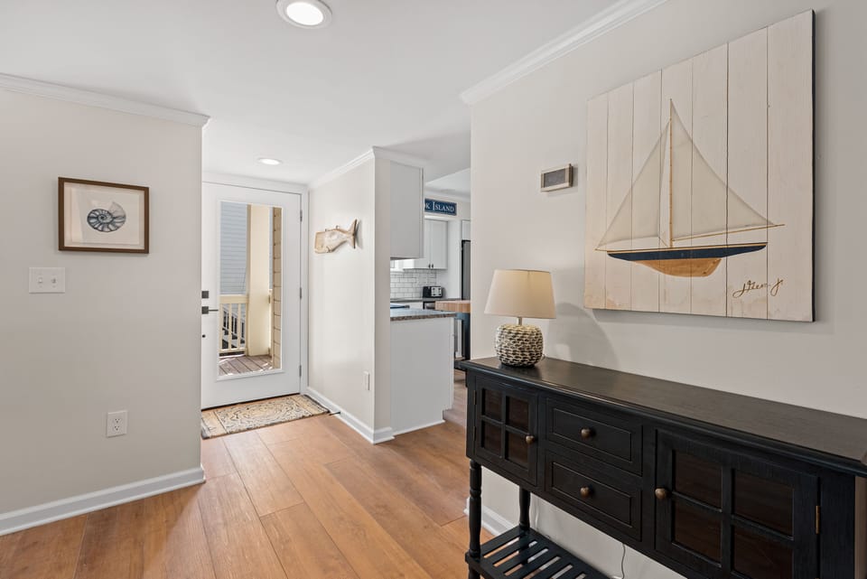 You enter through the front door into a light filled, beautifully decorated beach home.