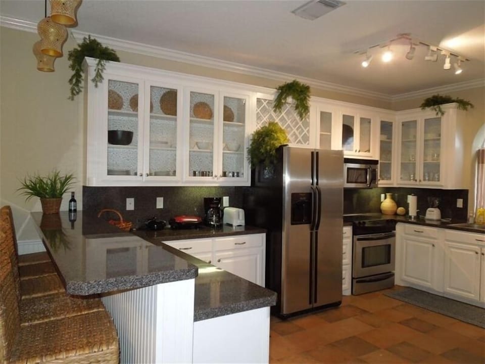 Spaces kitchen with upscale appliances and fine dining wares.