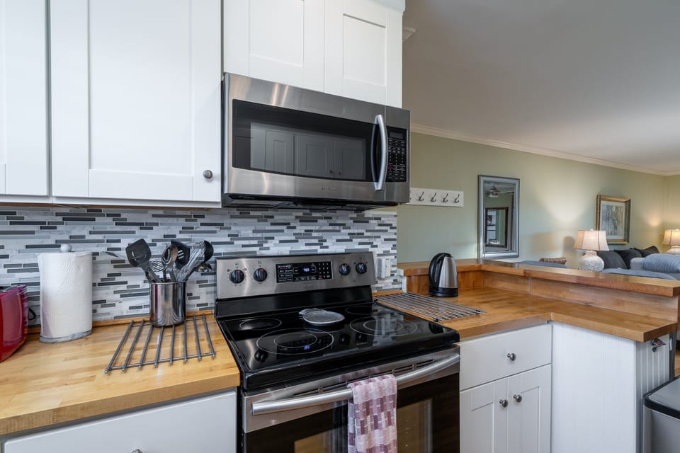 Stainless steel appliances and bar seating.