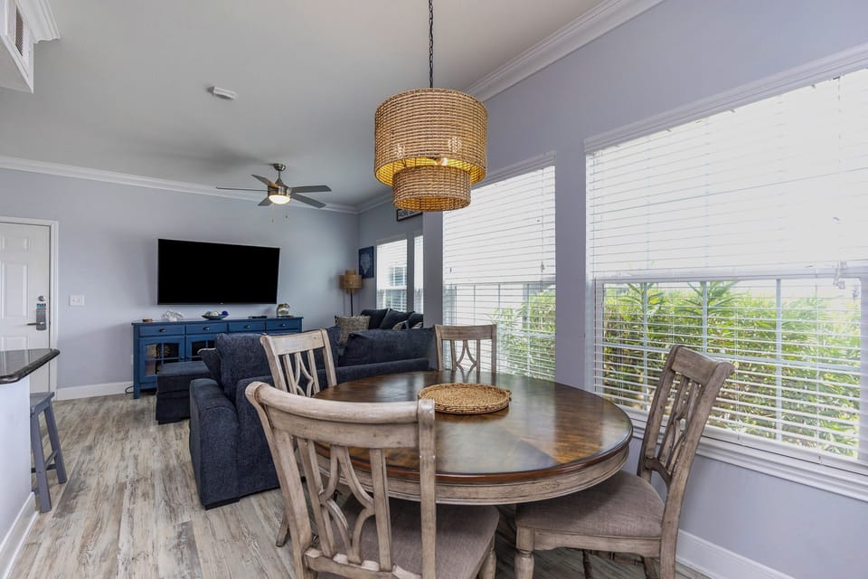 Gather around your elegant dining table while tropical breezes flow through bright windows, creating the perfect setting for memorable meals.
