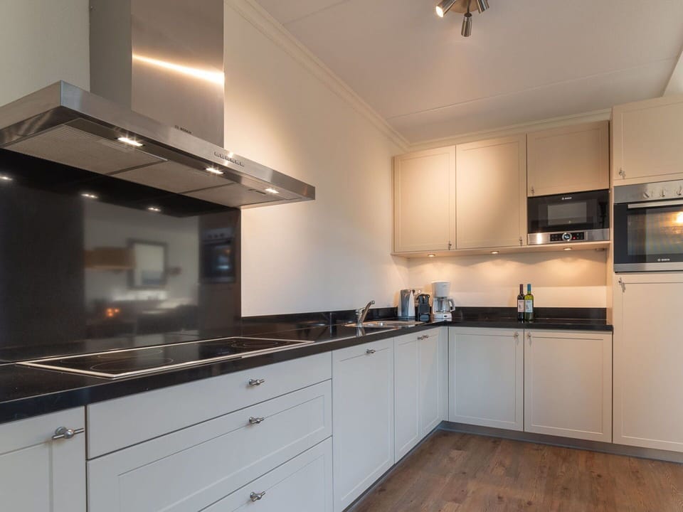 Countertop, Cabinetry, Property, Tap, Kitchen Stove, Kitchen, Kitchen Appliance, Wood, Lighting, Interior Design