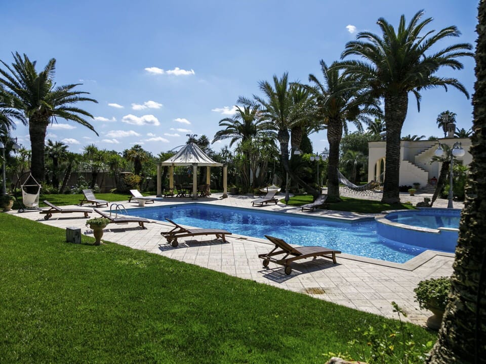 Water, Plant, Sky, Swimming Pool, Azure, Tree, Outdoor Furniture, Building, Sunlounger, Arecales