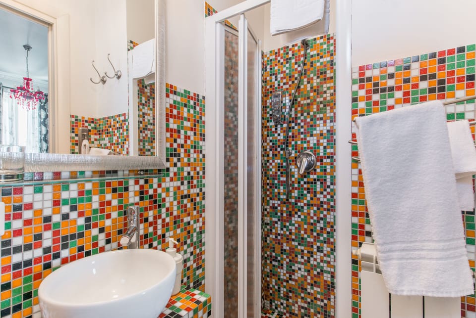 Shower, rainfall showerhead, hair dryer, towels