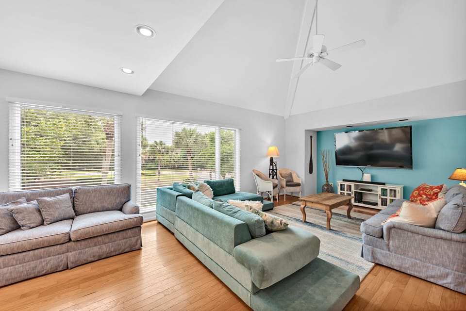 Enjoy the open living area. This bright home has hardwood floors and an inviting blue and white decor.