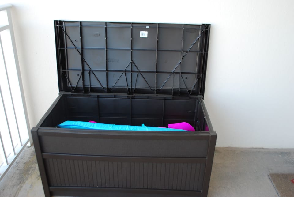 deck box filled with beach toys.