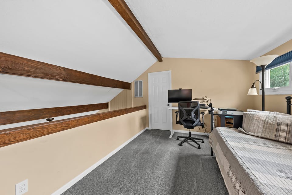 Upstairs is the loft which serves as the 4th bedroom. It is open to the living room below..