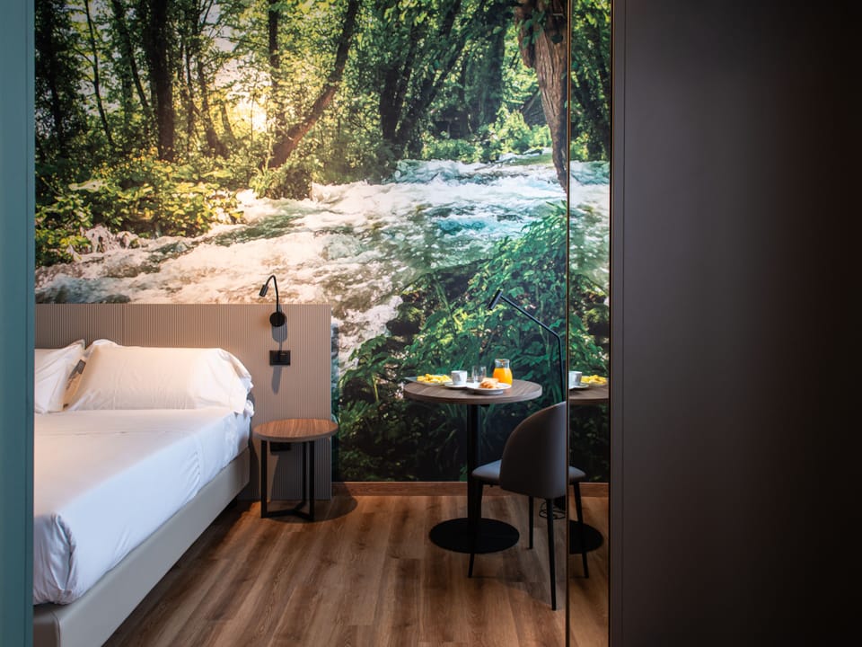 Deluxe Quadruple Room | Minibar, in-room safe, desk, laptop workspace