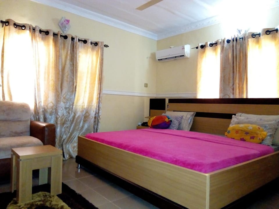 Desk, laptop workspace, blackout drapes, bed sheets