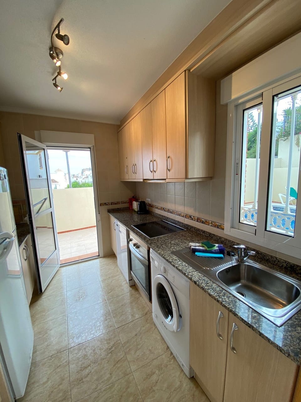 Kitchen with fridge freezer.