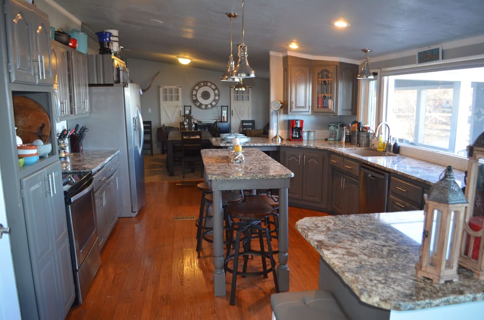 View of the large kitchen with island seating, looking into the dining room.