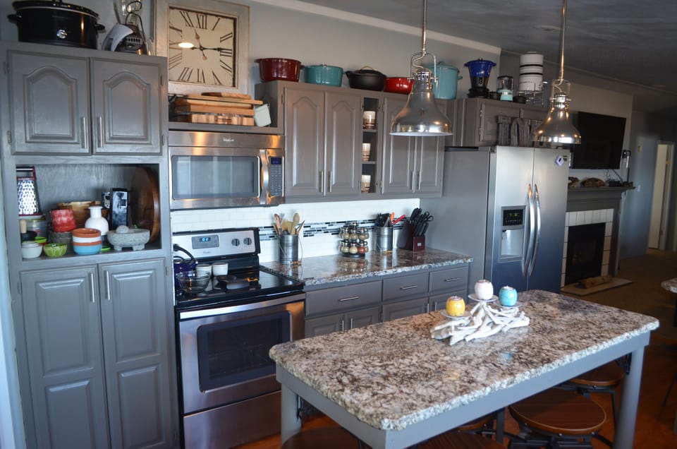 Large pantry, stove, large refrigerator, island with seating, pots.pans, etc.