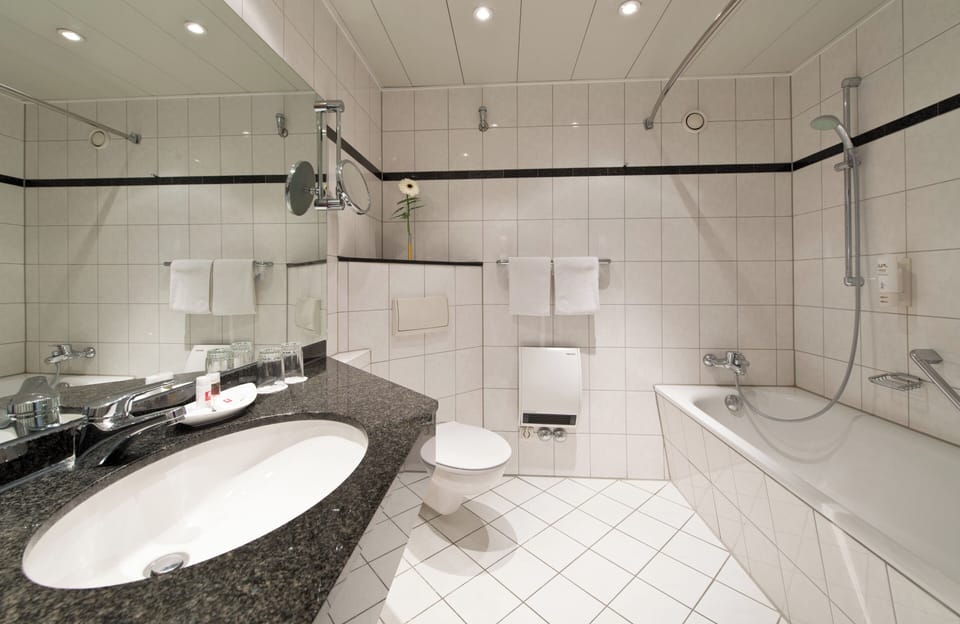 Bathtub, eco-friendly toiletries, hair dryer, towels