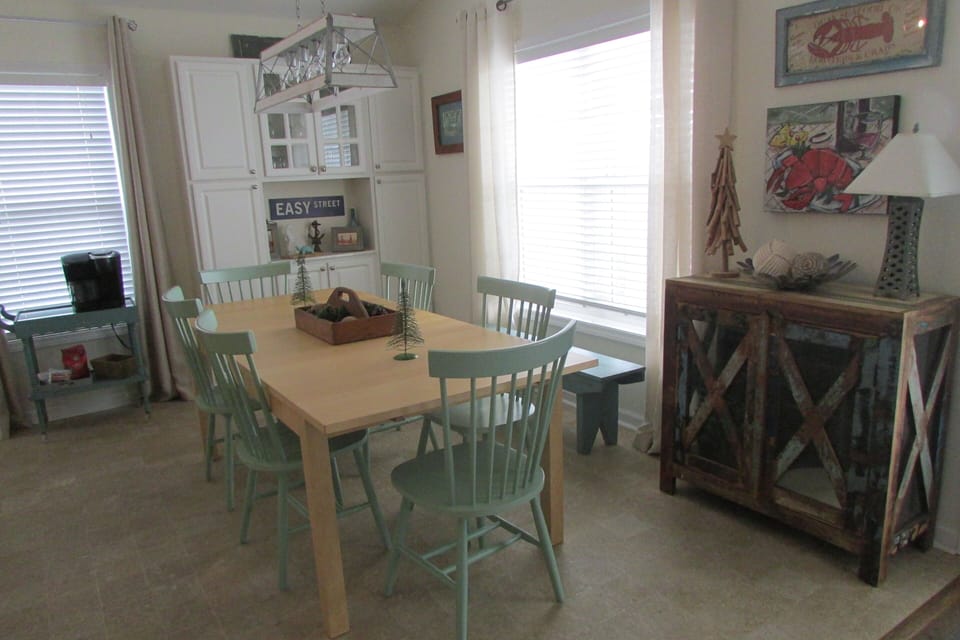 Dining area behind kitchen bar area.
Built in cabinet stocked with dishes.
