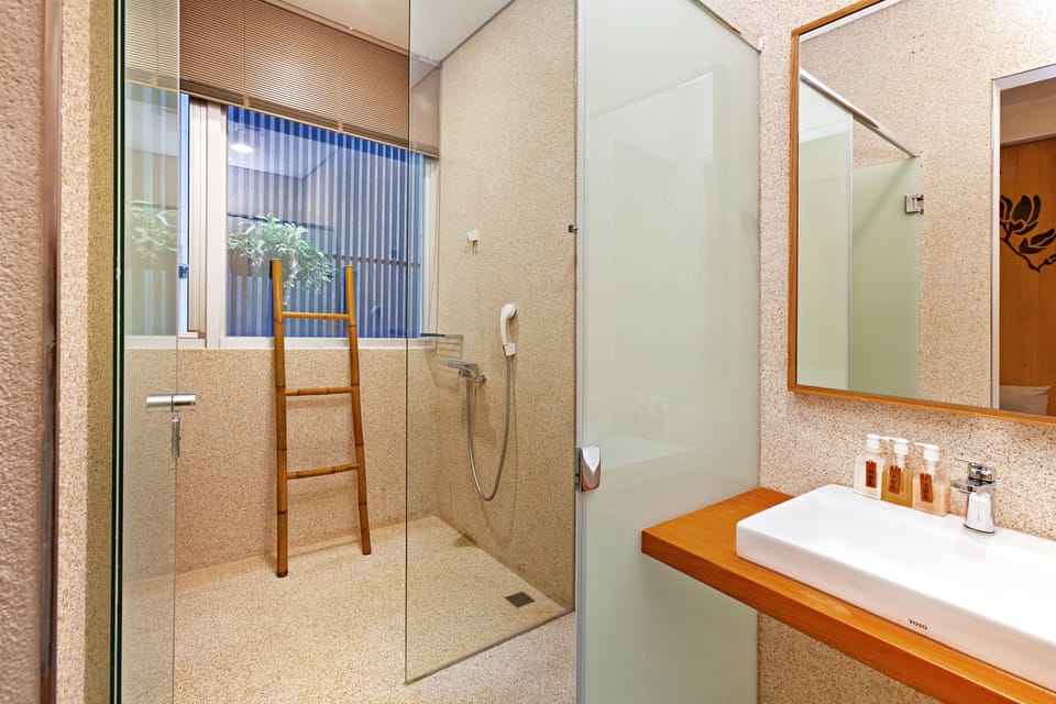 Designer toiletries, hair dryer, slippers, towels