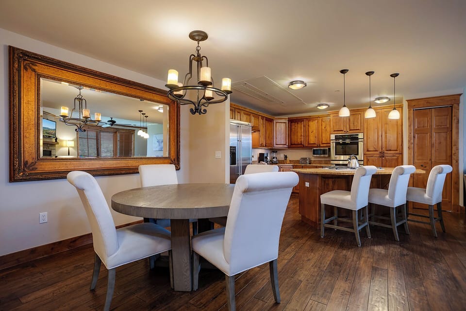 Gather around your elegant dining table or chef-inspired kitchen island for memorable meals with loved ones in this sophisticated space.