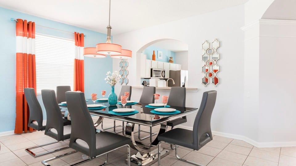 This dining room features a spacious table and comfy chairs, perfect for gathering with friends and family.  Make memories over delicious meals!