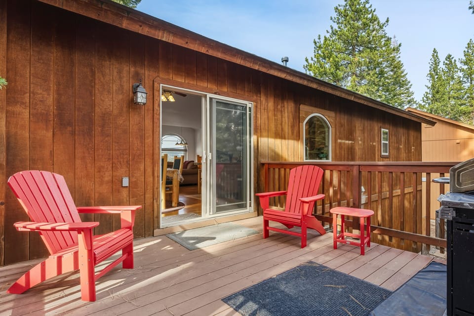 Another look at the deck, with sliding door, deck, railing, and outdoor chairs.