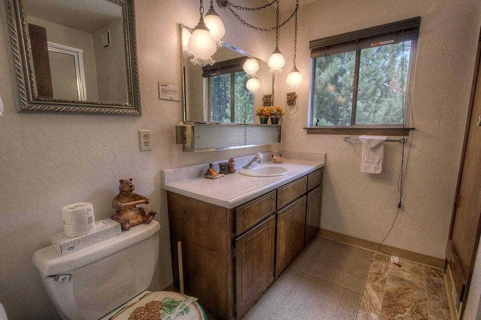 Bathroom with a long single vanity and a window.