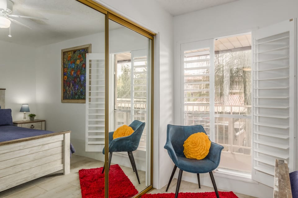 Guest bedroom with oversized 8' closet and floor to ceiling shuttered windows