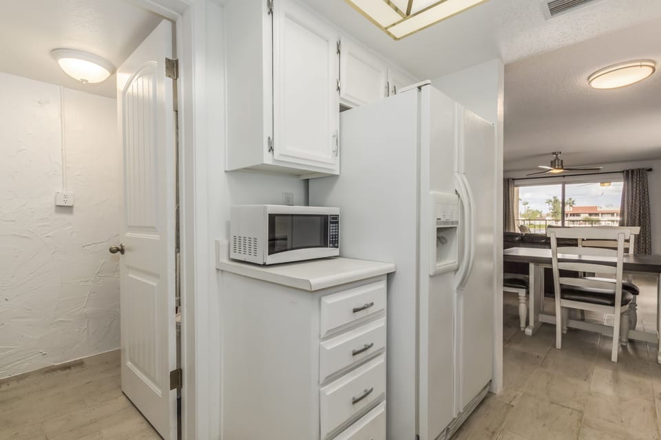 full size refrigerator and freezer with smaller microwave