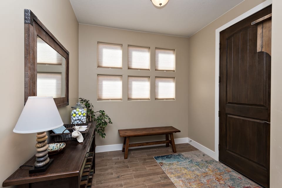 Front Entry - Welcome to I Could Live Here. Entry with bench and coat hooks, plus "experienced" golf balls to replace those lost while playing the area's many wonderful golf courses.