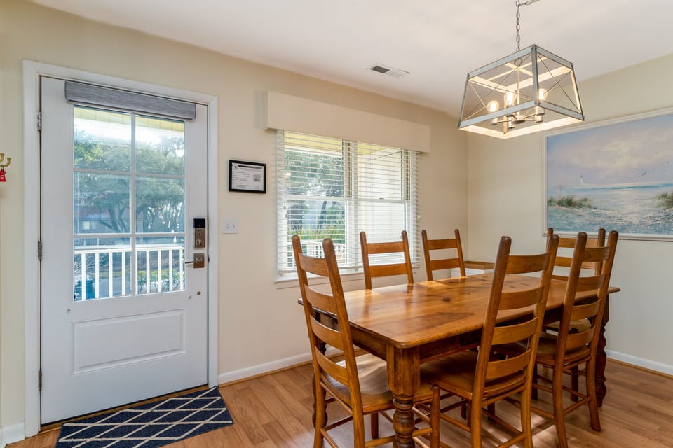 The dining area has a large table with seating for 6.  The perfect dinner gathering spot.