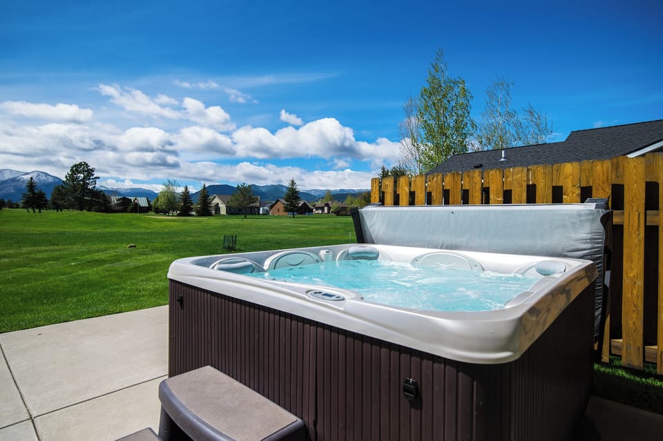 View the golf course and mountains while relaxing in the hot tub on patio.