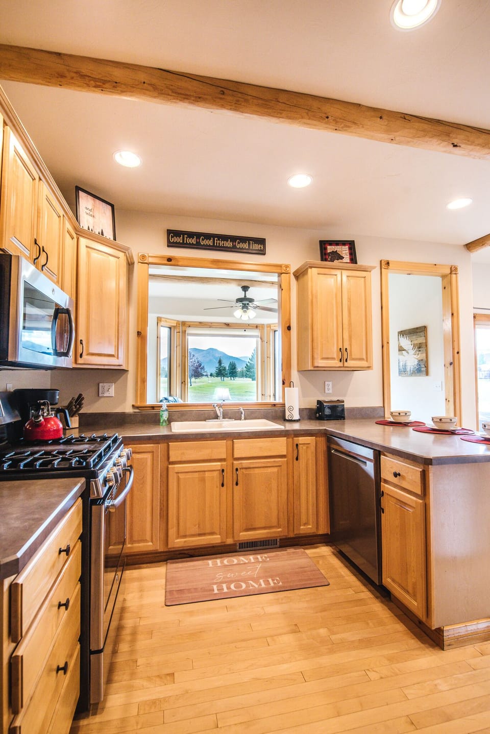 Kitchen with modern appliances and fully stocked for cooking and serving meals.