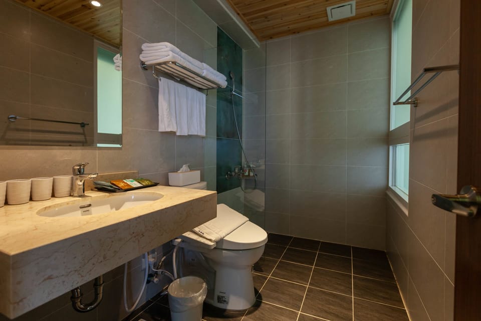 Family Quadruple Room, 2 Double Beds, Accessible, Non Smoking | Bathroom | Shower, hair dryer, slippers, towels