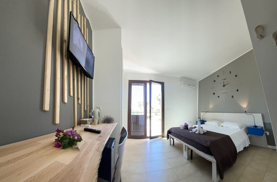 Deluxe Double Room, Sea View | Individually decorated, desk, laptop workspace, blackout drapes