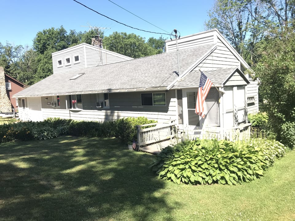 Front of house with main entrance to house on the right side.