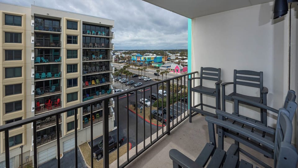 Enjoy a relaxing moment on the balcony with charming views of colorful buildings and a vibrant atmosphere