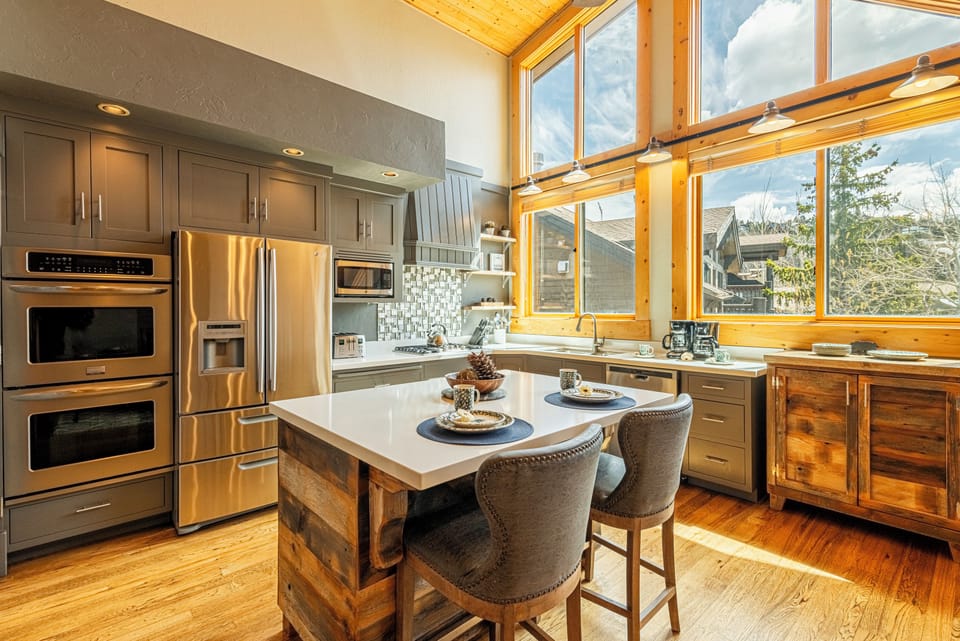 Fully equipped kitchen and stainless steel appliances, including a wine fridge
